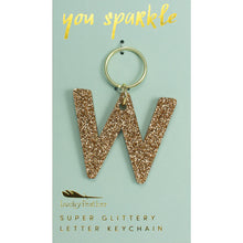 Load image into Gallery viewer, Gold glittery letter &quot;W&quot; keychain on a light blue card with &quot;you sparkle&quot; in gold text, displayed against a white background. 