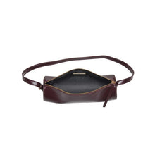 Load image into Gallery viewer, Dark brown vegan leather cylindrical shoulder bag shown with the top zipper open to reveal the black interior lining, displayed against a white background. 
