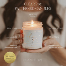 Load image into Gallery viewer, Candle with gold foil accents held by hands, surrounded by text detailing product features.