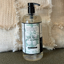 Load image into Gallery viewer, Archipelago Botanicals Bergamot Eucalyptus body wash in a clear bottle with black pump, styled against a textured cream fabric. 