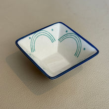 Load image into Gallery viewer, Square stoneware Geo dish with blue rim featuring clean lines,  teal curved line detail, and dot accents, shown on a neutral surface. 