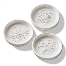 Load image into Gallery viewer, Secret Sauce Dish three round white ceramic sauce dishes each with a single embossed design in panda, fish, or flower, shown empty against a white background. 