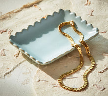 Load image into Gallery viewer, Light blue glazed ceramic scalloped rectangular trinket dish holding a gold chain necklace, displayed on a textured neutral surface.