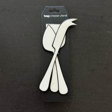 Load image into Gallery viewer, Monroe Enml Cheese Utensil Set white stainless steel utensils with white enamel finish and black outline design, set of three stacked together in packaging against a dark background. 
