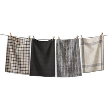 Load image into Gallery viewer, Canyon woven dishtowel set in cotton with assorted black and ivory patterns including check, solid, and stripe designs, hanging on a line with wooden clothespins against a white background. 