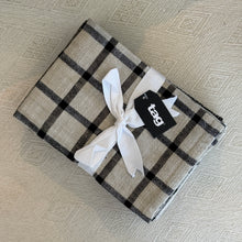Load image into Gallery viewer, Canyon woven dishtowel set in cotton with black and ivory check pattern, folded and tied with white fabric ribbon and branded tag, shown against a neutral textured surface.  
