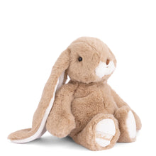 Load image into Gallery viewer, Friendly Kanini soft brown bunny plushie with long floppy ears, white muzzle, small tan nose, and white paw pads seated on a white background. 