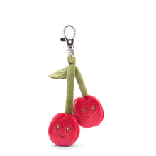 Load image into Gallery viewer, Red cherry plush bag charm with two cherries, green stems and leaf, stitched  face details, and silver clip, displayed on a white background. 