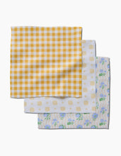 Load image into Gallery viewer, Geometry Luxe washcloths, set of three, featuring assorted yellow gingham, yellow dot, and blue floral patterns, displayed overlapping on a white background.