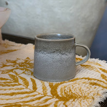Load image into Gallery viewer, Aquarius Sage stoneware espresso cup with reactive glaze on a cloth surface.