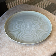 Load image into Gallery viewer, Aquarius Sage stoneware dinner plate with reactive glaze and concentric line pattern, on a marble surface. 