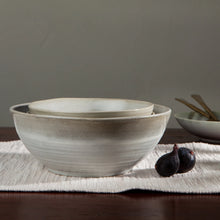 Load image into Gallery viewer, Aquarius Sage stoneware serving bowl with reactive glaze, nested bowls displayed on a white textured cloth with figs on a dark wood surface. 