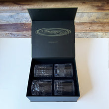 Load image into Gallery viewer, Whirlwind spinning cocktail glasses set of four displayed in open black gift box with four assorted textured glass styles, displayed on a white surface.  