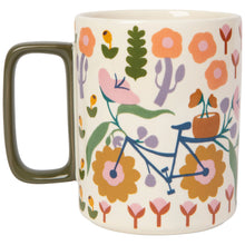 Load image into Gallery viewer, Petal Power Studio stoneware mug with rectangular olive-colored handle, floral pattern, and bicycle design, displayed on a white background. 