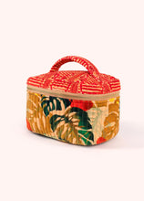 Load image into Gallery viewer, Quilted cotton velvet vanity case featuring a multicolor tropical leaf pattern in green, tan, yellow, and orange with an orange patterned top, structured handle, and zipper closure, displayed on a white background.  