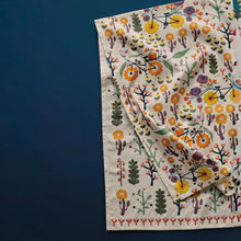 Load image into Gallery viewer, Petal Power cotton linen dishtowel with multicolor floral and bicycle pattern on an ivory background with a red floral bottom border, folded and stacked.
