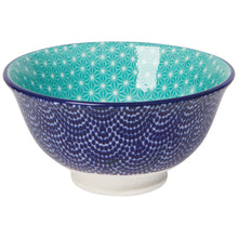 Load image into Gallery viewer, Blue Waves porcelain pinch bowl with blue stamped dot wave pattern exterior and blue rim, teal interior with white geometric pattern, and white pedestal base, side view,  on a white background. 