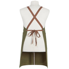 Load image into Gallery viewer, Olive Branch Mason cotton apron in olive green with brown criss-cross back straps and metal grommets, back view, displayed on a mannequin. 
