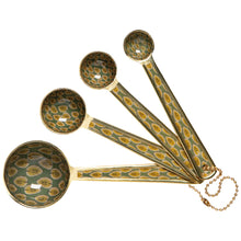 Load image into Gallery viewer, Brio enamel steel measuring spoons with green and gold block print leaf pattern and matte gold finish, set of four, displayed on a white background.