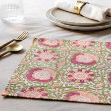 Load image into Gallery viewer, Zinnia block print cotton placemat with pink and peach floral and white vine pattern on an olive background, displayed on a table setting. 