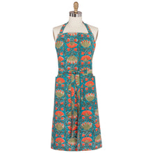 Load image into Gallery viewer, Allure Block Print Apron, cotton apron with hand block-printed floral pattern in coral  and olive on a teal background, featuring a neck strap, waist ties, and side-by-side pockets, displayed on a dress form against a white background. 