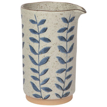 Load image into Gallery viewer, Vine Element Pitcher, stoneware pitcher with reactive glaze and blue vine pattern on cream speckled surface, beige base, and brown rim with spout, displayed on a white background. 