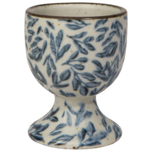 Load image into Gallery viewer, Danica Heirloom stoneware egg cup, featuring blue leaf pattern on a cream background with brown rim, displayed on a white background. 