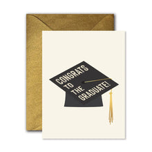 Load image into Gallery viewer, Congrats To The Graduate Card, white graduation card with black graduation cap design, gold foil tassel accents, Congrats To The Graduate white text, and glittery gold envelope against white background. 