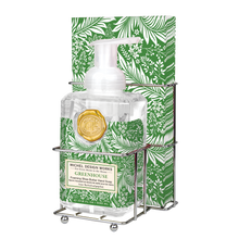 Load image into Gallery viewer, Michel Design Works Greenhouse foaming shea butter hand soap pump bottle with gold seal in double compartment metal caddy with paper guest towels, both featuring white botanical pattern on green background against a white background. 