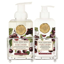 Load image into Gallery viewer, Michel Design Works Dark Cherry foaming hand soap and body lotion pump bottles with gold seal in metal caddy, featuring cherry fruit and botanical label design against a white background. 