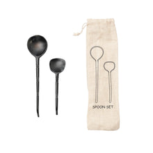 Load image into Gallery viewer, Horn Spoons Set, set of two dark carved natural horn spoons in two sizes with ringed handle indentations, matching natural-colored drawstring storage pouch with two black spoon outline designs against white background. 