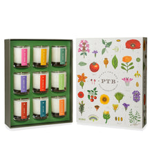 Load image into Gallery viewer, Plant the Box Votive Gift Set, KOBO set with nine glass jar votive candles in assorted fragrances with multicolored labels arranged in green insert tray beside illustrated botanical gift box with multicolored flowers, leaves, and fruit, against white background. 