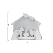 Load image into Gallery viewer, White stoneware Nativity with reactive glaze and dimensions 5.5&quot; x6&quot; in black text. Against a white background. 