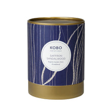 Load image into Gallery viewer, Saffron Sandalwood Coastal Candle, KOBO pure soy candle in blue patterned packaging with gold-toned rim and base, against white background. 