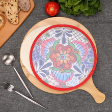 Load image into Gallery viewer, Day of the Dead Fabric Tortilla Warmer, round with colorful floral and tile-inspired pattern and red trim, shown with tortillas, displayed on wooden board with bread, tomato, lettuce, and utensils. 