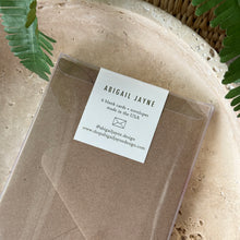 Load image into Gallery viewer, Sweet Peaches Thank You Card Box Set, brown kraft envelopes in clear packaging box with white brand label on neutral stone surface with green fern fronds in background. 