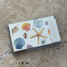 Load image into Gallery viewer, Sea Shells Mini Cards Box Set, mini card set with watercolor seashell illustrations including starfish, sand dollar, and assorted shells, clear plastic case, on neutral stone surface. 