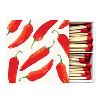 Load image into Gallery viewer, Spicy Peppers Boxed Matches, boxed wooden safety matches with watercolor red pepper design on white sliding cover, red-tipped sticks, partially open, against white background. 
