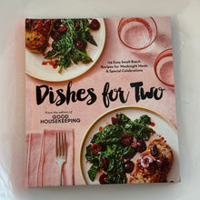 Load image into Gallery viewer, Dishes for Two by Good Housekeeping, soft blush pink illustrated hardcover featuring two plated meals with chicken, greens, and cherries against a white background. 
