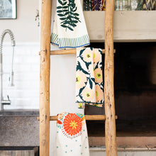 Load image into Gallery viewer, Kitchen Tea Towel, three colorful patterned kitchen tea towels with floral and botanical prints, striped accents, and decorative trim, displayed on a rustic wooden ladder in a kitchen setting.