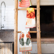 Load image into Gallery viewer, Kitchen Tea Towel, three colorful patterned kitchen tea towels with orange floral prints and striped accents, displayed on a rustic wooden ladder in a kitchen setting.  