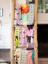Load image into Gallery viewer, Kitchen Tea Towel, assorted colorful patterned kitchen tea towels displayed on a rustic wooden ladder in a kitchen setting. 