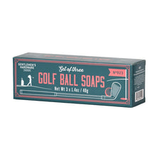 Load image into Gallery viewer, Golf Ball Soaps, rectangular dark green product box with coral pink vintage-style lettering, golfer silhouette illustration, and golf club graphic, displayed at an angled view against a white background. 