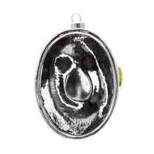 Load image into Gallery viewer, Caviar Ornament, back view of an oval glass ornament with a silver surface, a gold pull tab partially visible, and a silver-tone hanging cap, against a white background. 