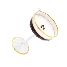Load image into Gallery viewer, Espresso Martini Ornament, angled view of a clear coupe ornament with a gold rim and matching gold-trimmed base, layered dark brown espresso and frothy white foam topped with three brown coffee beans, scalloped lower bowl, clear stem, and white hanging loop, against white background.  