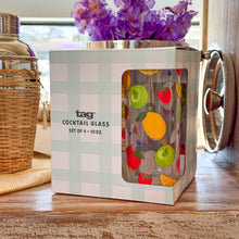 Load image into Gallery viewer, Fresh Pick Drinks Glass Set, light blue and white gingham-style packaging box with a cutout window showing a fruit-patterned glass tumbler, displayed with wicker-wrapped stainless steel shaker and purple flowers on a rustic wood surface. 