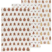 Load image into Gallery viewer, Cookie Floursack Towels, three white unbleached cotton dish towels arranged flat and overlapping side by side, one with rows of brown gingerbread houses and people, another with brown and cream bells and holly, and the third with brown and cream decorated trees, snowflakes, and stars, against a white background.  