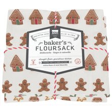 Load image into Gallery viewer, Cookie Floursack Towels, set of three unbleached white cotton dish towels with rows of brown gingerbread houses and brown gingerbread people, folded and tied together with a red-and-white cord and a white product label bordered in dark gray, against a white background. 