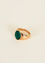 Load image into Gallery viewer, Gold Malachite Signet Ring, 18K gold-plated signet ring with an oval emerald green malachite stone with dark diagonal banding against a cream background. 