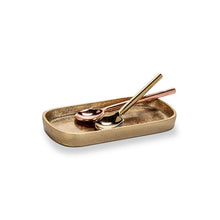 Load image into Gallery viewer, Small Gold Oval Tray, small lightweight oval tray with a warm burnished gold finish, raised rim, and rounded corners, shown with gold-tone and rose gold-tone spoons, against a white background. 